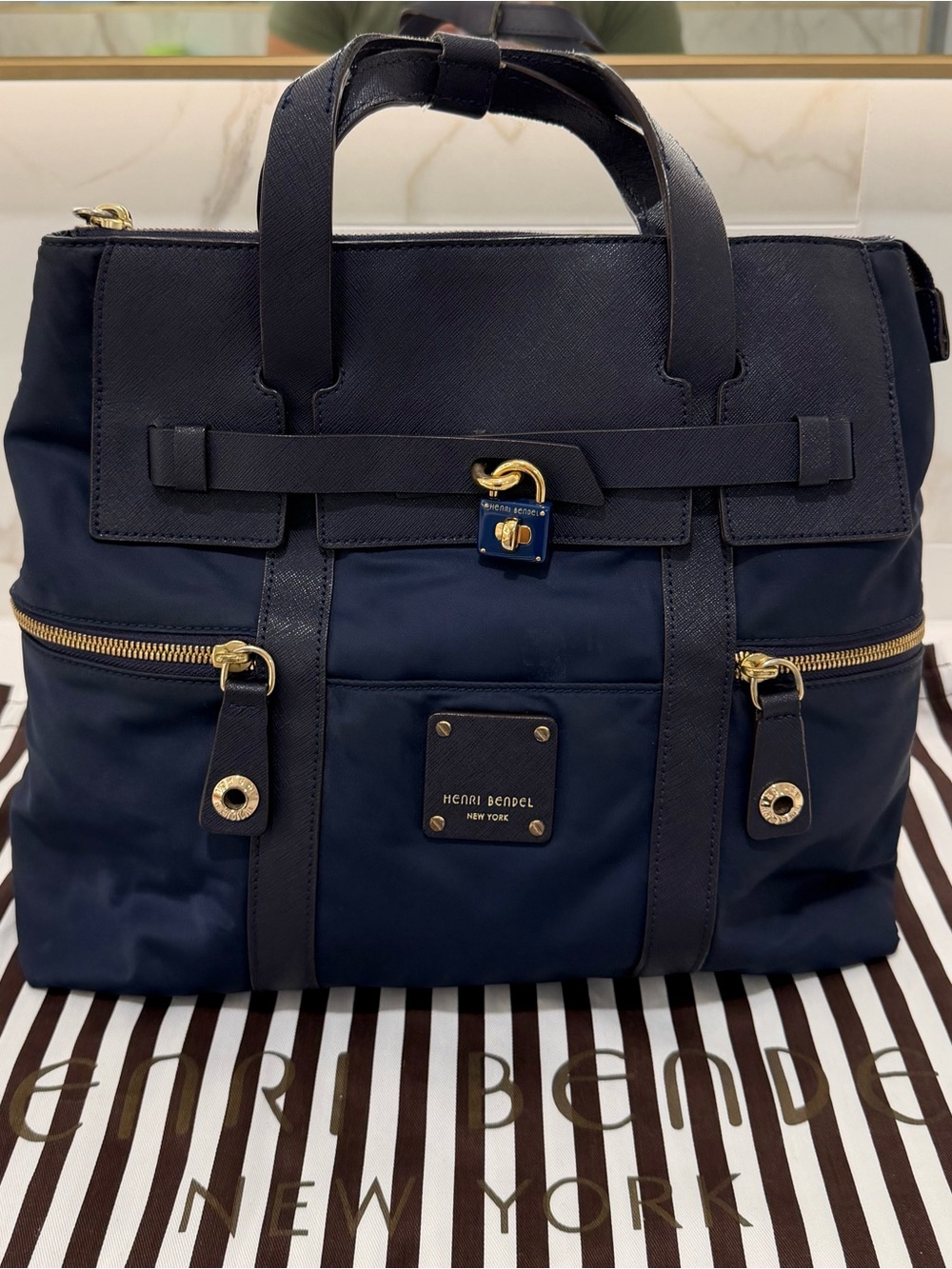 Henri Bendel navy backpack with gold hardware